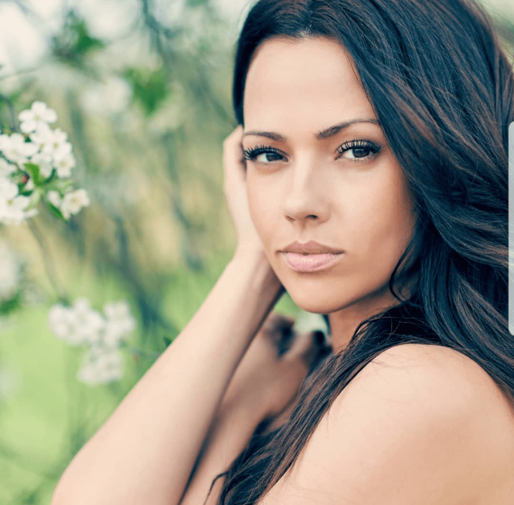 A woman with long hair and bare shoulders.